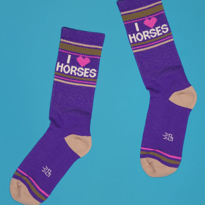 Lifestyle shot of 'I Heart Horses' socks on a bright blue background.