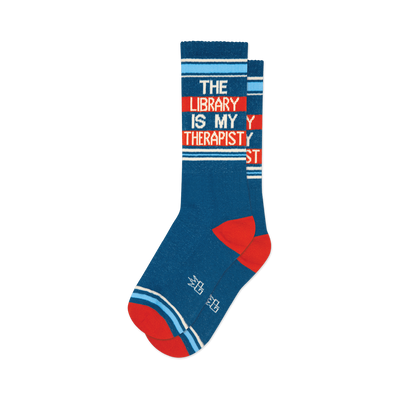Pair of teal crew socks with orange and white stripes. Text reads: 'The Library Is My Therapist'.