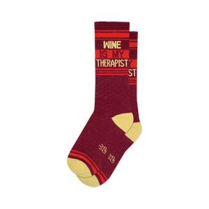 Pair of burgundy crew socks with orange and yellow stripes and the text 'Wine Is My Therapist'.