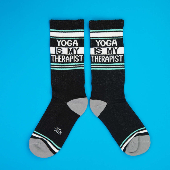 Close-up shot of 'Yoga Is My Therapist' socks, showcasing the design details.