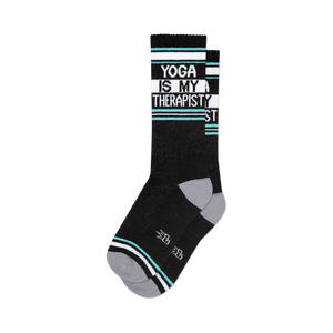 Pair of black crew socks with teal and white stripes and the text 'Yoga Is My Therapist'.