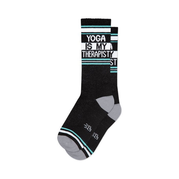 Pair of black crew socks with teal and white stripes and the text 'Yoga Is My Therapist'.
