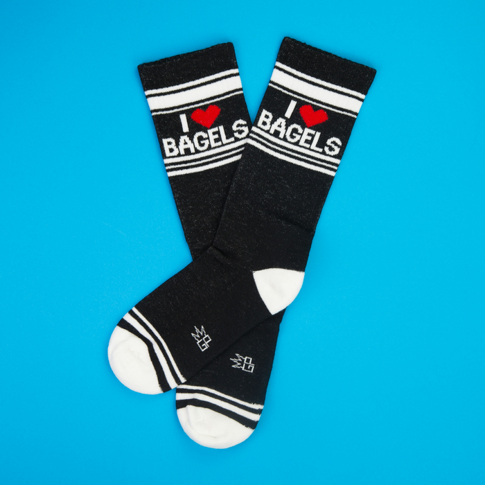 Flatlay of 'I Heart Bagels' socks on a bright blue background.