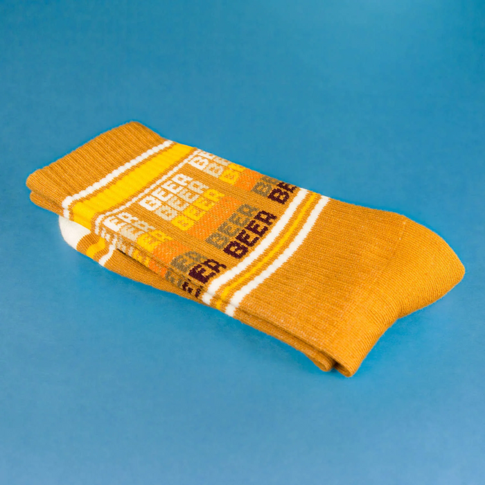 Close up of mustard yellow 'Beer' socks showcasing the detail.