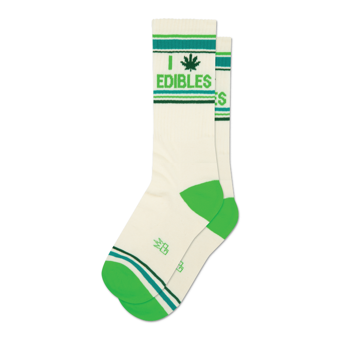 Pair of cream crew socks with green and teal stripes and a marijuana leaf with 'I Edibles' text. }}