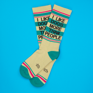 Lifestyle shot showcasing a pair of 'I Like Dogs More Than People' socks.