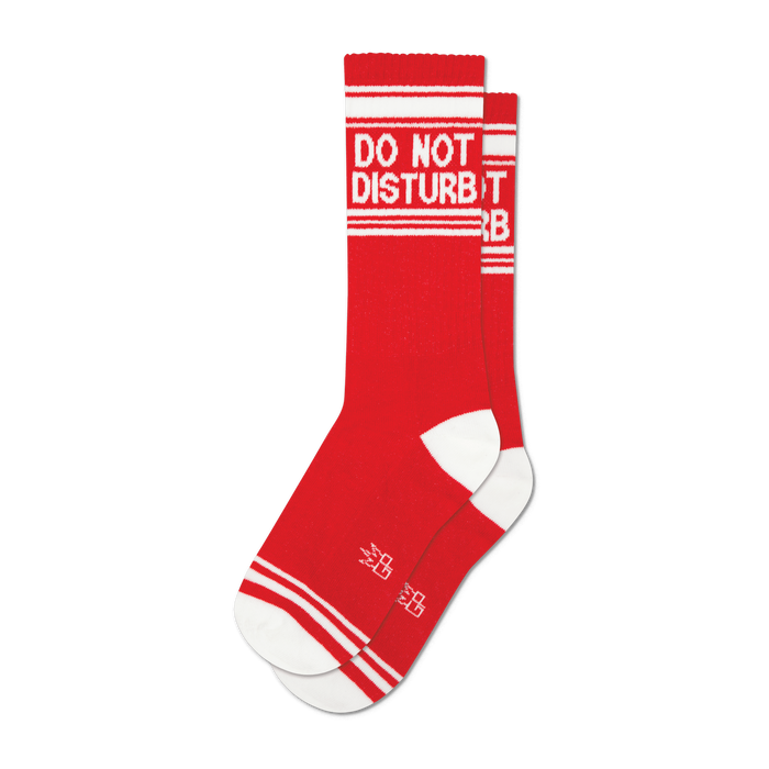 Pair of red crew socks with a white 'Do Not Disturb' message and white stripes. Small logo near the toes.