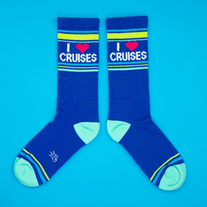 Flat lay product shot of a pair of 'I Heart Cruises' socks on a bright blue background.