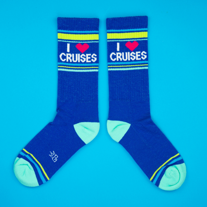 Flat lay product shot of a pair of 'I Heart Cruises' socks on a bright blue background.