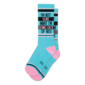 Pair of teal crew socks with pink and black stripes.  Text reads: 'I'm not sure what I'm doing out of bed'.