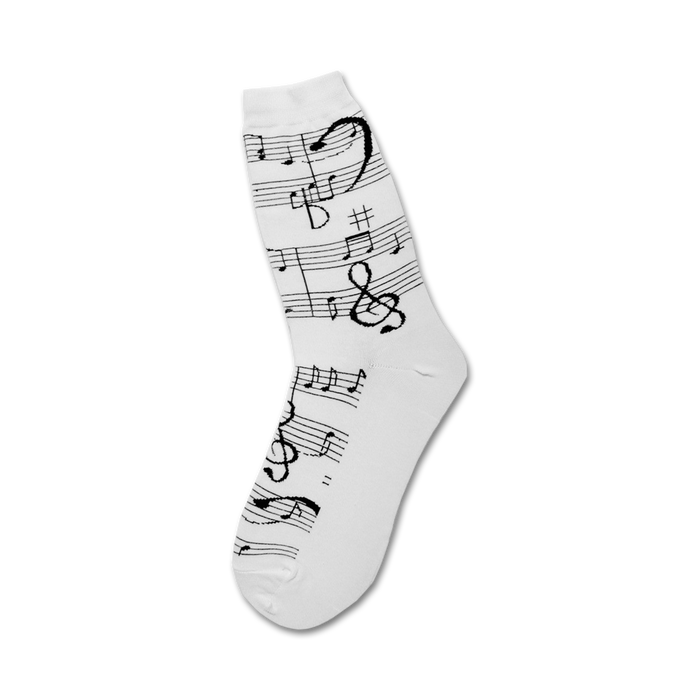 Close-up of white crew socks with black musical notes and clefs.
