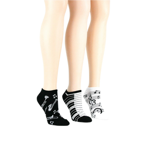 Lifestyle shot: three pairs of musical socks on mannequin legs.