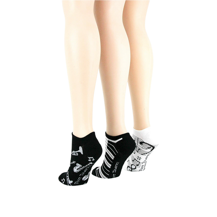Lifestyle shot: different angle showing three pairs of musical socks on mannequin legs.
