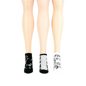 Lifestyle shot: another different angle showing three pairs of musical socks on mannequin legs.