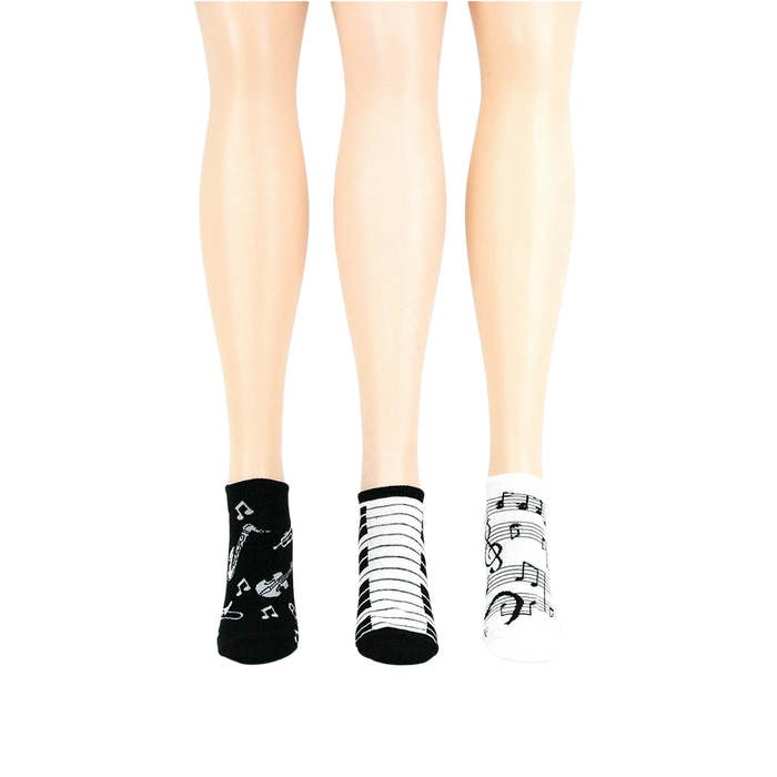 Lifestyle shot: another different angle showing three pairs of musical socks on mannequin legs.