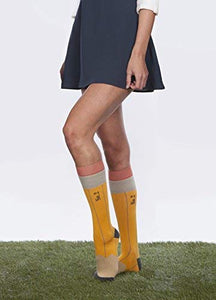 Lifestyle shot showing a woman wearing a pair of No. 2 Pencil socks with a navy skirt.