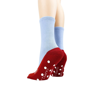 Flatlay showcasing both socks, highlighting the red slipper design and non-skid dots on the bottom.