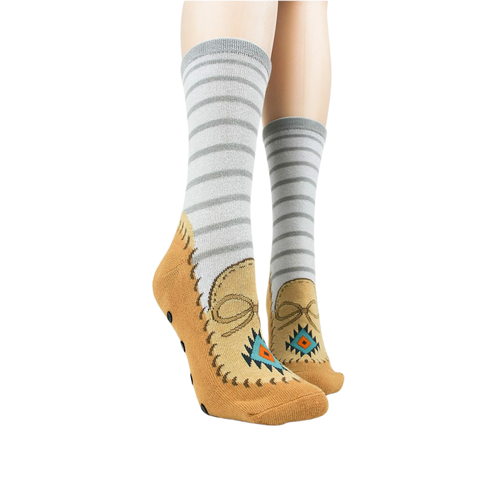 A pair of gray socks with brown toes and black soles with polka dots. The socks have the words 
