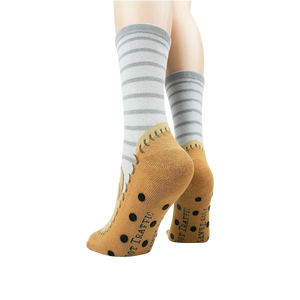 Back view of the socks highlighting the non-skid grips and the tan moccasin design.