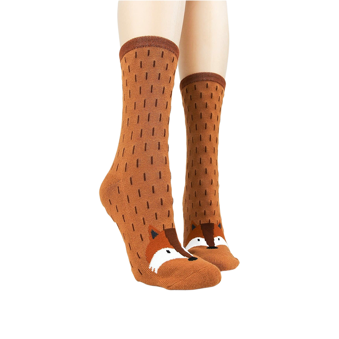 A pair of brown socks with white polka dots and a white and brown fox pattern on the back. The socks are being modeled by a person who is not shown in the picture.