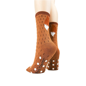 A pair of brown socks with white polka dots and a white and brown fox pattern on the back. The socks are being modeled by a person who is not shown in the picture.