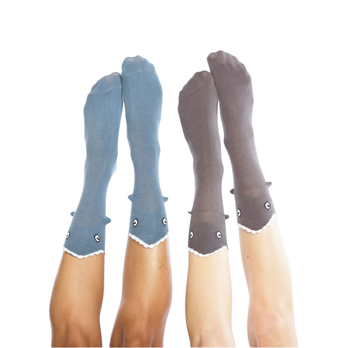 Pair of Shark Bite 3D socks, one grey and one blue, on crossed legs.
