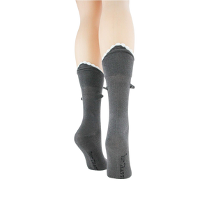 Back view of grey Shark Bite 3D socks on a mannequin leg, showcasing the scalloped cuff.