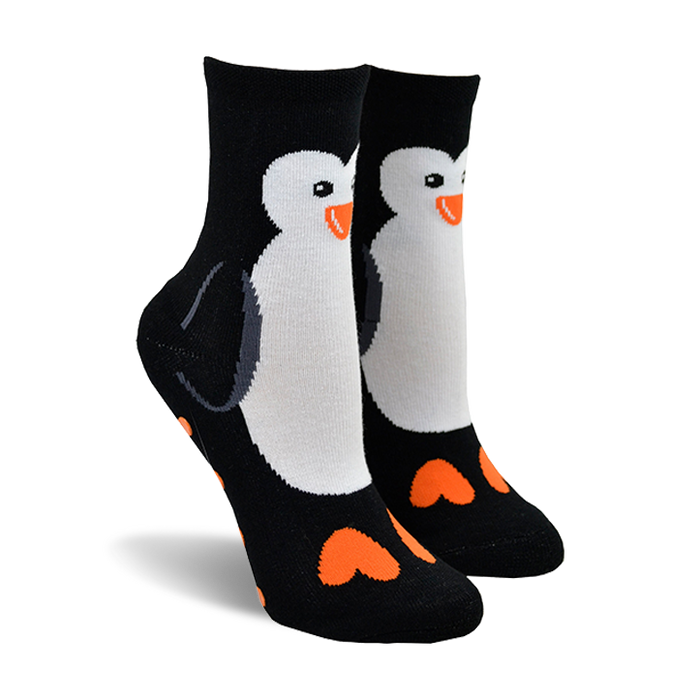 Pair of black crew socks with a white penguin design and orange heart-shaped feet. }}