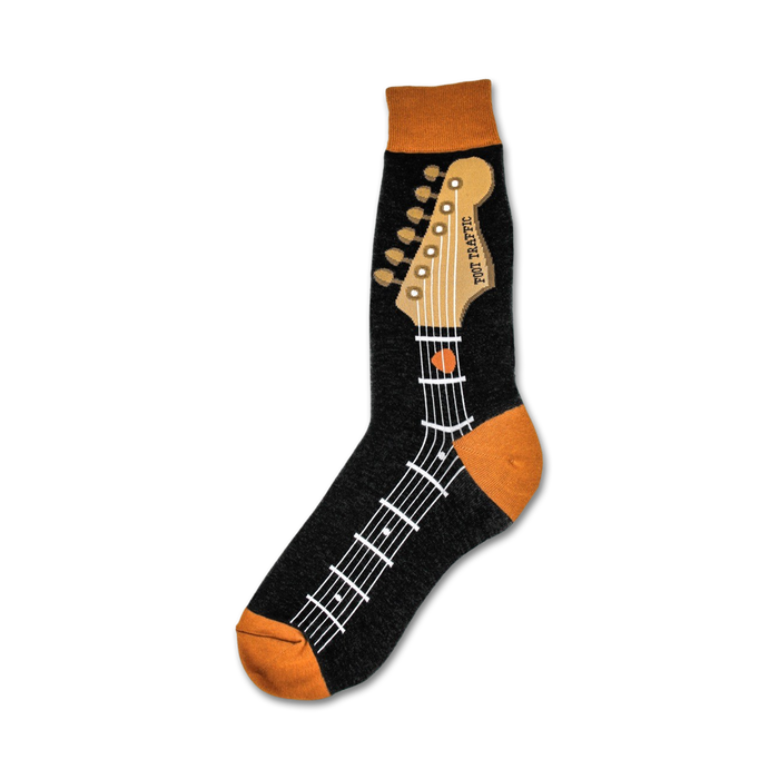 A close-up of black crew socks with an orange guitar neck design. The guitar's headstock and fretboard are detailed on the socks.