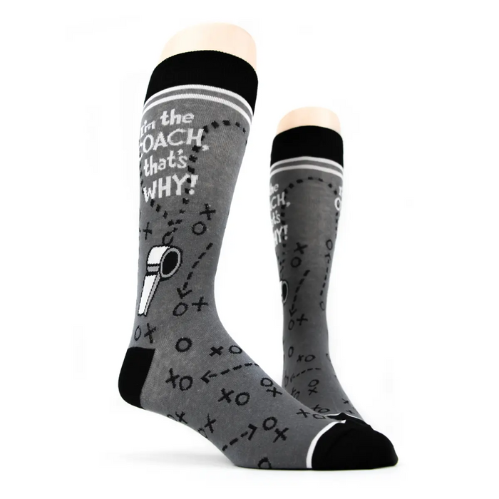 Pair of 'I'm the Coach' socks on a mannequin, showing the full design.