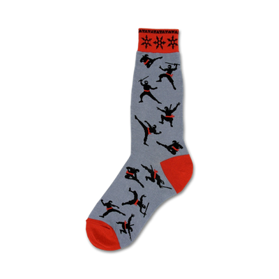 Grey crew socks featuring black ninja silhouettes and red accents.  The sock cuff has a red and black repeating star pattern.