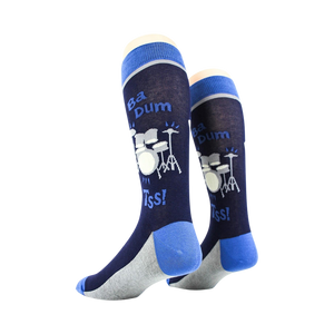 A pair of blue socks with a drum set design and the words 