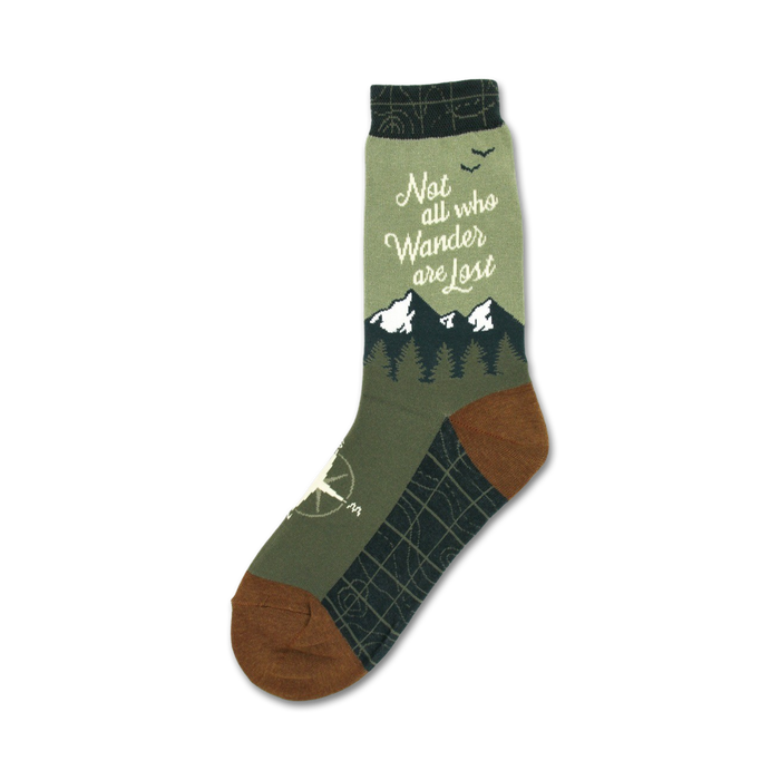 women's crew socks in green with brown toes and heels, featuring 'not all who wander are lost' text, mountain range, birds, compass, and trees. 