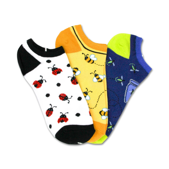 Three pairs of low-cut socks. One pair has ladybugs on a white background, one has bees on yellow, and one has fireflies on navy. }}