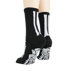 Flat lay image showcasing a pair of black skeleton socks.