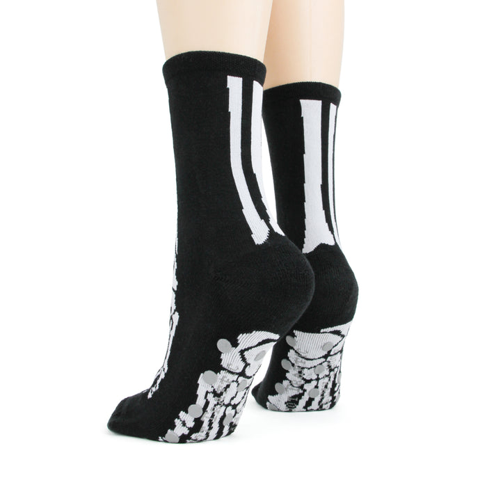 Close-up shot of the bottom of the black skeleton socks highlighting the grey non-skid dots.