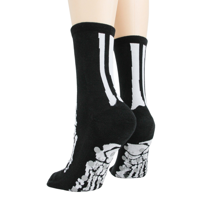 Flat lay image showcasing a pair of black skeleton socks.