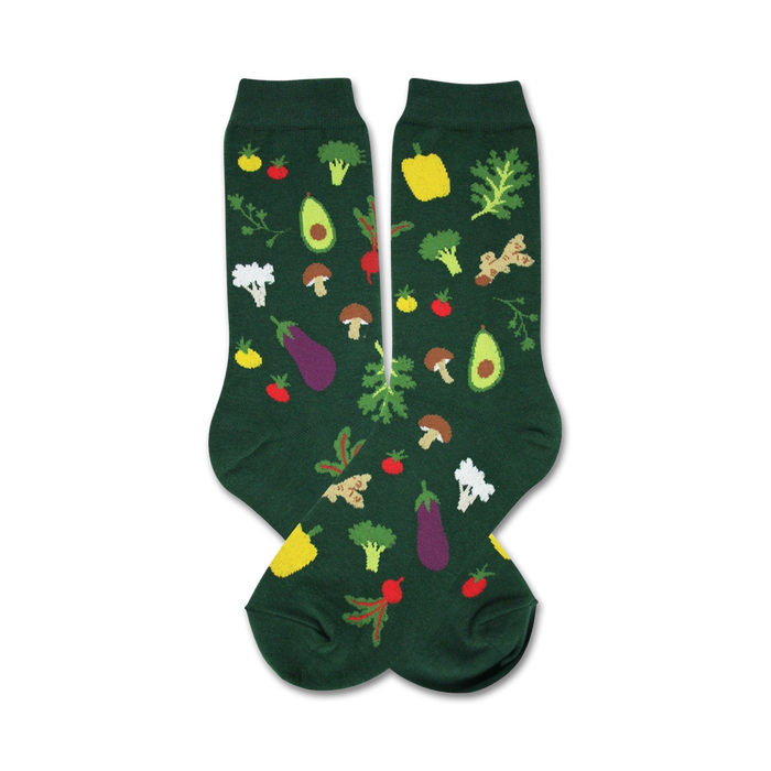A pair of dark green crew socks with a whimsical pattern of colorful vegetables like avocado, eggplant, broccoli, and tomatoes. }}