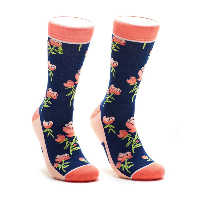 A pair of navy blue crew socks with a pattern of coral peonies and green stems. The socks have a coral-colored cuff. }}