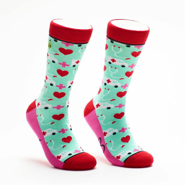 Crew socks in red, pink, and mint green. The design features white ambulances, pink hearts, and red crosses. }}