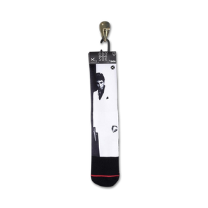 Close-up of Scarface socks hanging on a retail display tag.
