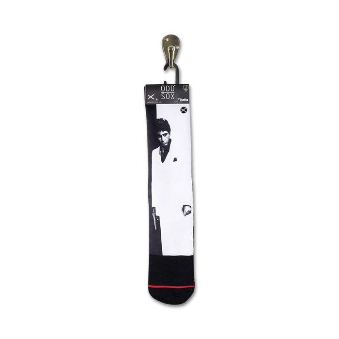 Close-up of Scarface socks hanging on a retail display tag.