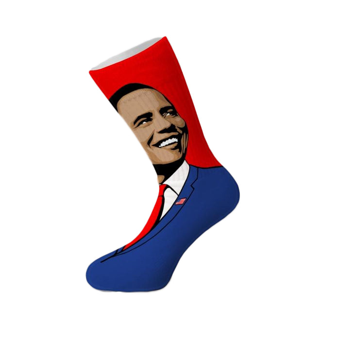 Crew socks featuring a pop art portrait of Barack Obama in a blue suit against a red background. The American flag is subtly visible on his lapel. }}