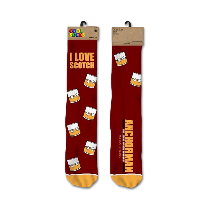 A pair of crew socks in burgundy with a repeating pattern of yellow whiskey glasses and the text 'I Love Scotch' and 'Anchorman'. }}