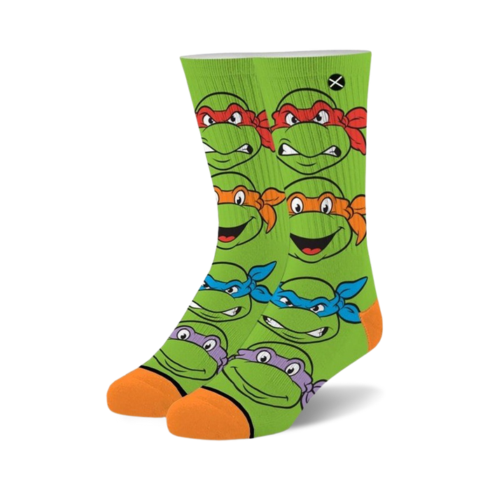 Teenage Mutant Ninja Turtles crew socks. Green background with orange and different colored masks. Features all four turtle's faces. }}