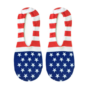 A pair of no-show socks with an American flag pattern. The socks are red and white striped with blue stars on a white background. The words 