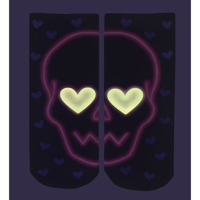 Close-up of the Love Skull Glow socks in the dark, showing the glow-in-the-dark effect.