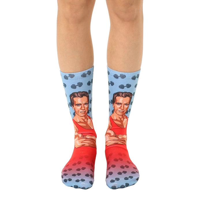 Crew socks featuring Arnold Schwarzenegger's image in red and blue, with dumbbell pattern.