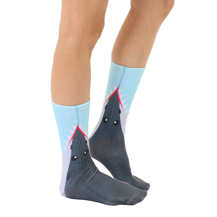 Lifestyle shot showing a person wearing the Shark Bite socks. The socks are positioned to show the shark design effectively.