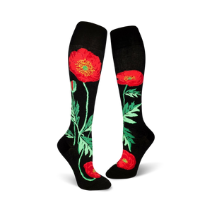 Pair of black knee-high socks adorned with red poppies and green foliage.